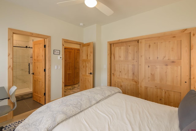 tiled bedroom featuring connected bathroom, a closet, and ceiling fan