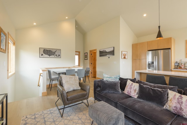 living area featuring recessed lighting, light wood-style floors, and high vaulted ceiling