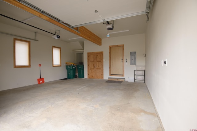 garage with electric panel and a garage door opener
