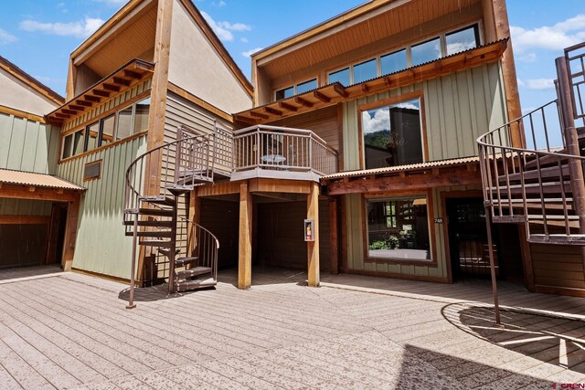 365 S Tamarron Dr Unit 747, Durango, CO 81303 - back of property with stairs, a deck, and board and batten siding