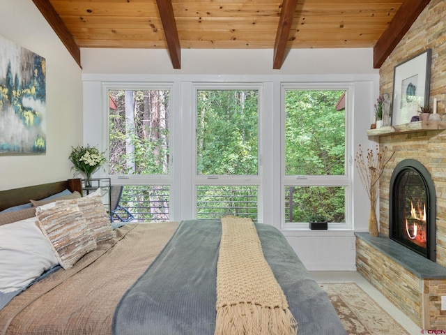 226 Lake Fork Junction Rd, Ophir, CO 81426 - bedroom with wood ceiling, a stone fireplace, vaulted ceiling with beams, and multiple windows