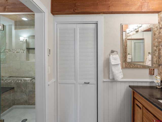 226 Lake Fork Junction Rd, Ophir, CO 81426 - full bathroom with a stall shower, a closet, vanity, and a wainscoted wall