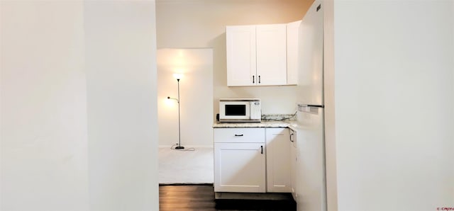 laundry area with wood finished floors