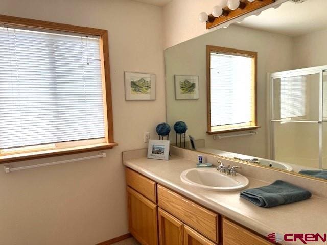 30022 Rd L, Mancos, CO 81328 - bathroom with vanity and a shower with shower door