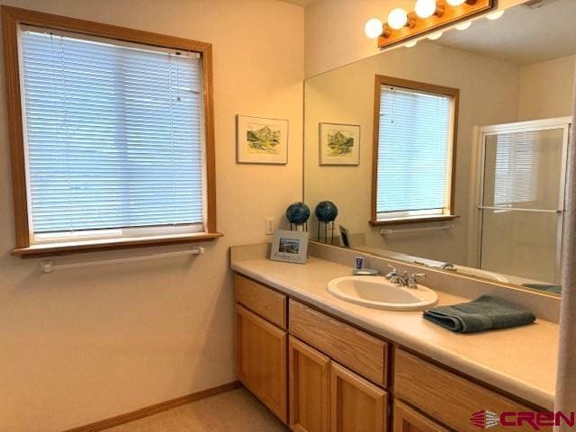 30022 Rd L, Mancos, CO 81328 - bathroom with vanity, a wealth of natural light, baseboards, and a shower