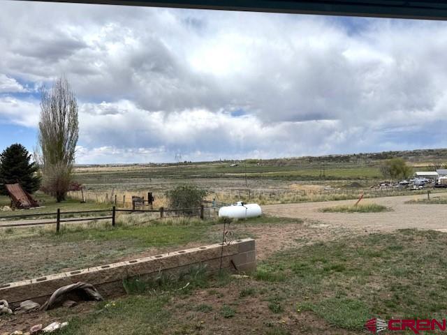 30022 Rd L, Mancos, CO 81328 - view of yard featuring fence and a rural view