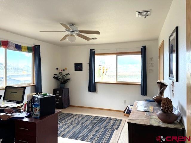 30022 Rd L, Mancos, CO 81328 - home office featuring visible vents, baseboards, and ceiling fan