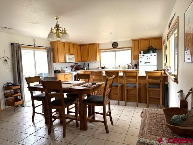30022 Rd L, Mancos, CO 81328 - dining area featuring a wealth of natural light, visible vents, and light tile patterned flooring