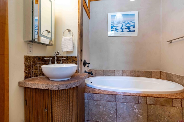 bathroom with vanity and a bath