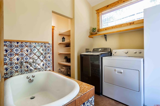 interior space with a bathtub, independent washer and dryer, and built in features