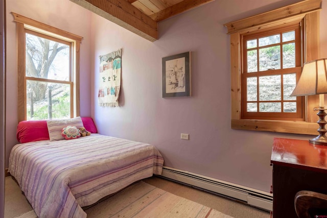 bedroom with a baseboard radiator, beam ceiling, and multiple windows