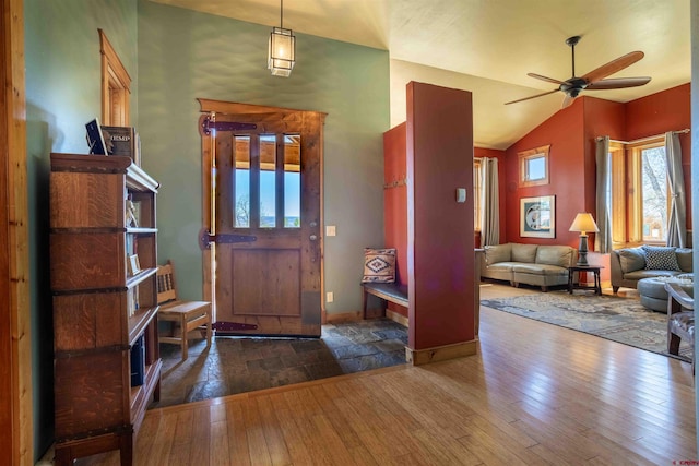 entrance foyer with ceiling fan, lofted ceiling, baseboards, and hardwood / wood-style floors
