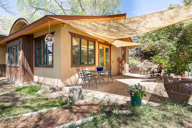 exterior space with a patio area and stucco siding