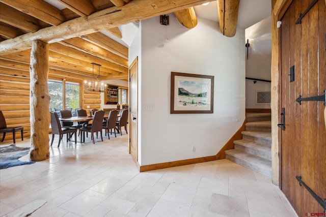 interior space with beam ceiling, a notable chandelier, log walls, baseboards, and visible vents