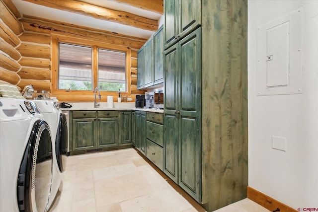 clothes washing area featuring rustic walls, a sink, electric panel, separate washer and dryer, and cabinet space