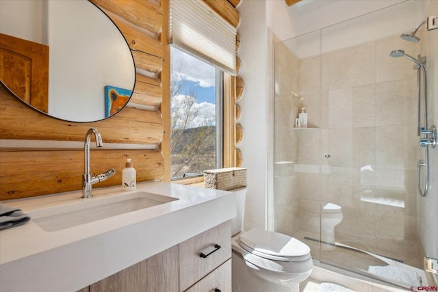 bathroom with a stall shower, vanity, and toilet
