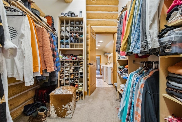 walk in closet with washing machine and clothes dryer and carpet floors