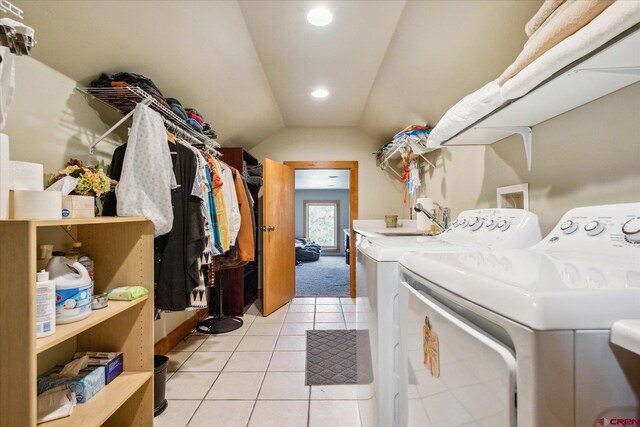laundry area with light tile patterned floors, laundry area, recessed lighting, and washer and clothes dryer
