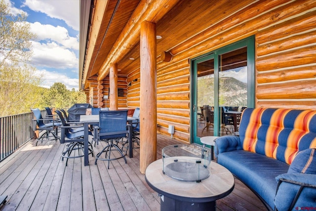 wooden terrace featuring outdoor dining space