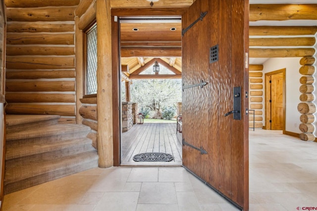 entryway with rustic walls and stairway
