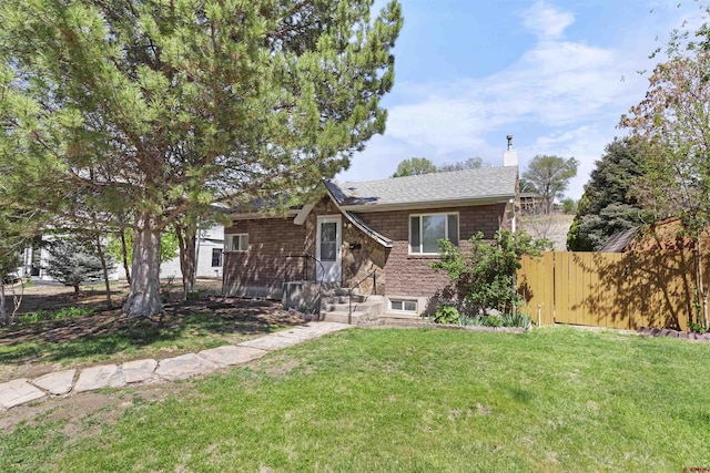 416 Howard St, Delta, CO 81416 - ranch-style home featuring fence, a front lawn, and a chimney