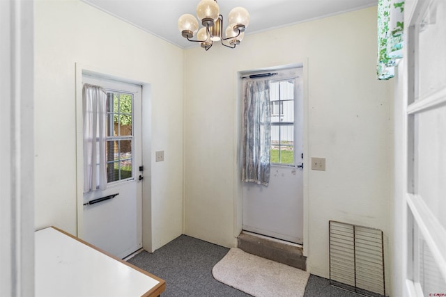 416 Howard St, Delta, CO 81416 - doorway with carpet flooring, a wealth of natural light, and a notable chandelier
