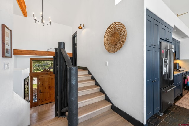 stairs featuring a chandelier