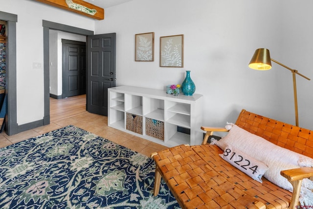 bedroom featuring light tile patterned floors and baseboards