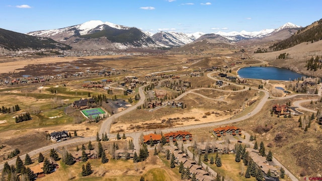 drone / aerial view with a water and mountain view