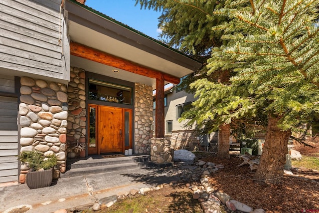 property entrance with stone siding