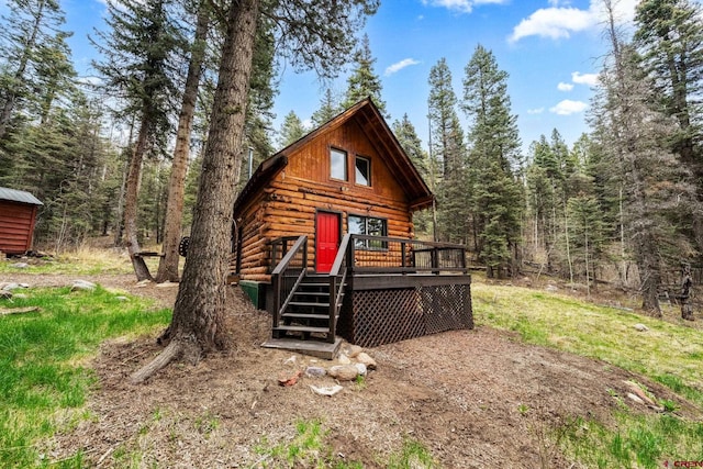 view of outbuilding featuring a view of trees