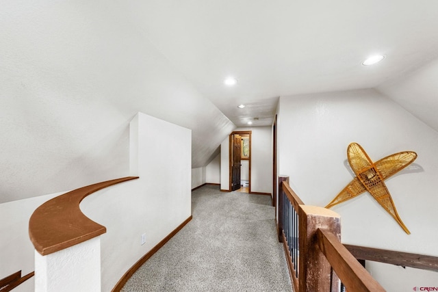 corridor featuring carpet flooring, an upstairs landing, baseboards, vaulted ceiling, and recessed lighting