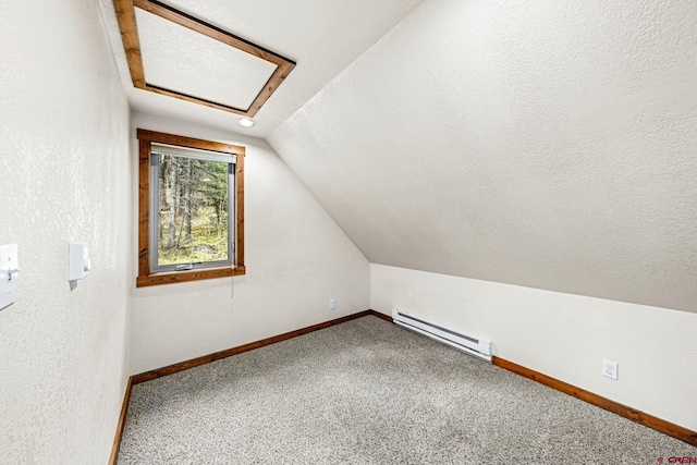 bonus room with a baseboard heating unit, attic access, vaulted ceiling, carpet floors, and baseboards