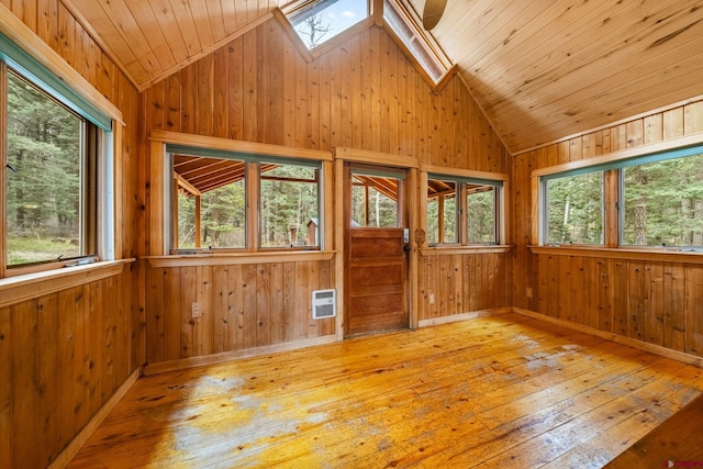 empty room featuring plenty of natural light and vaulted ceiling with skylight
