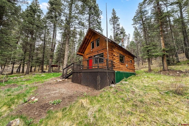 exterior space with a deck and log exterior