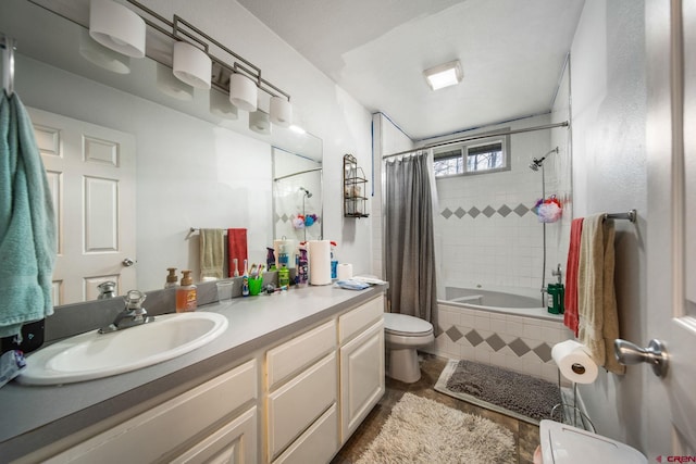 bathroom with toilet, tiled shower / bath combo, vanity, and tile patterned floors