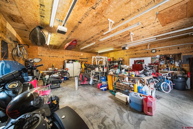 garage featuring a workshop area and a garage door opener