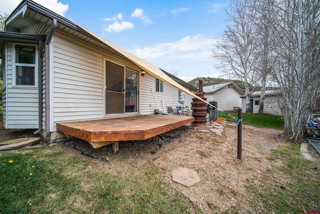 back of house with a wooden deck
