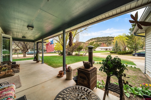 view of patio / terrace with a mountain view and a porch