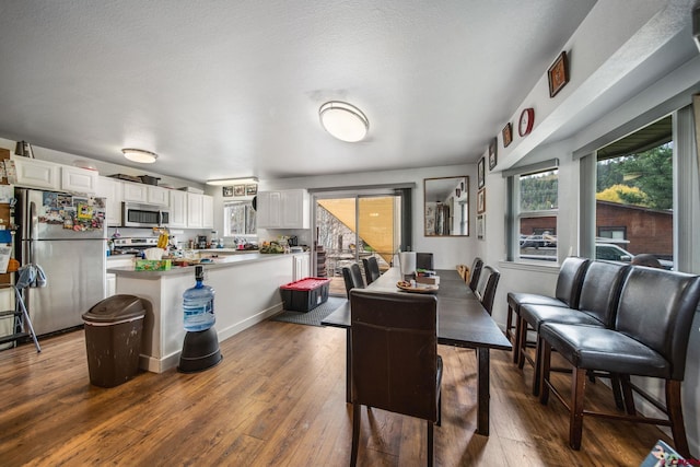 dining space with dark wood-style floors