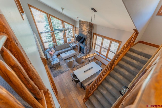 living area with stairs, a healthy amount of sunlight, and wood finished floors
