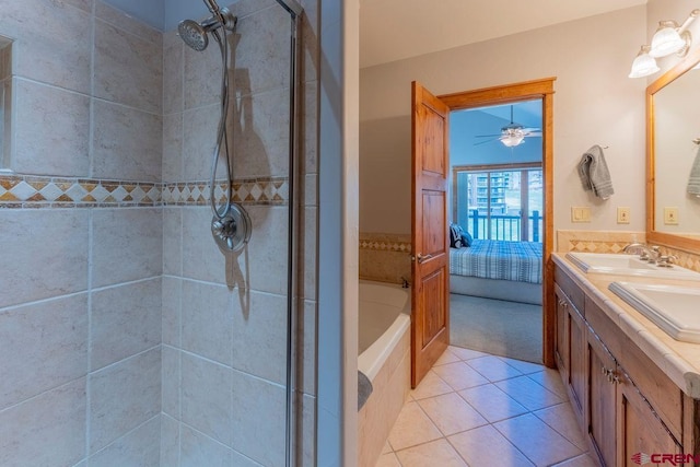 full bathroom featuring ensuite bathroom, tiled shower, tile patterned floors, and a sink