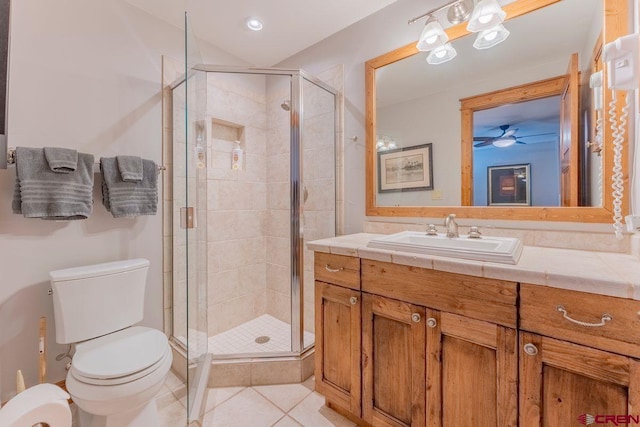 full bath with a stall shower, tile patterned flooring, toilet, and vanity