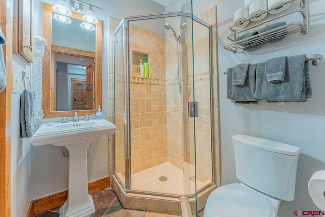 bathroom with toilet and a stall shower