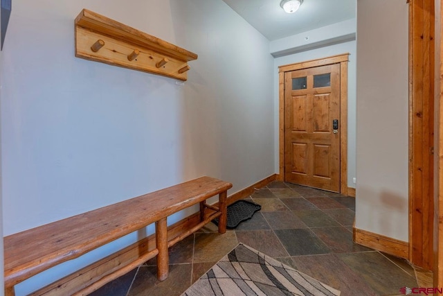 mudroom with baseboards and stone finish floor