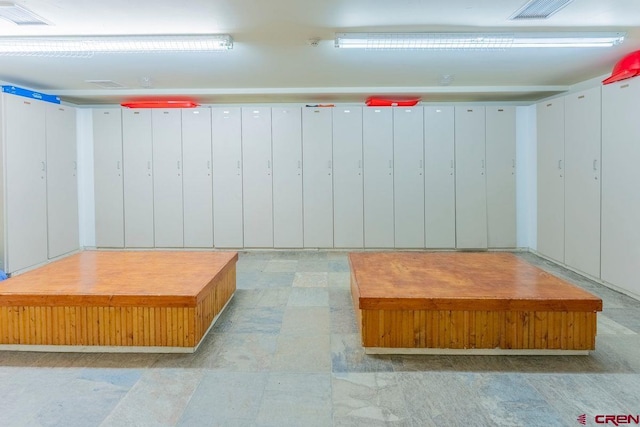 interior space with light floors and visible vents