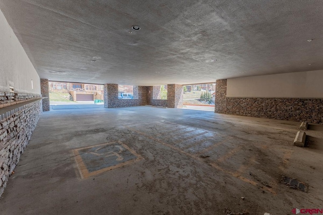 unfurnished living room featuring a wealth of natural light, a fireplace, and concrete flooring