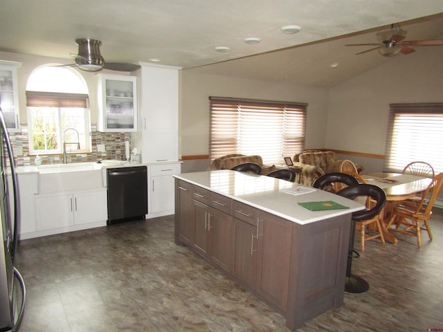kitchen with a healthy amount of sunlight, light countertops, dishwashing machine, and a ceiling fan