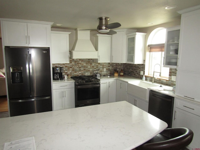 kitchen featuring stainless steel gas range oven, black dishwasher, refrigerator with ice dispenser, custom exhaust hood, and ceiling fan