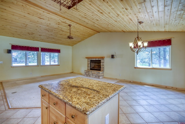 369 Beaver Cir, Pagosa Springs, CO 81147 - kitchen with plenty of natural light, open floor plan, lofted ceiling, light tile patterned floors, and a fireplace